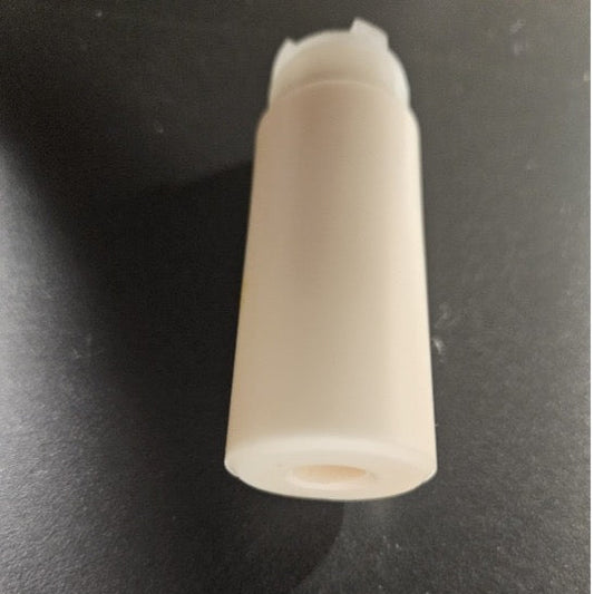 A small off-white plastic cylindrical component with a threaded top, photographed on a dark textured surface.